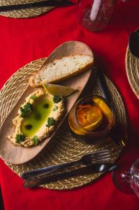 a plate of food with a sandwich on a table at Nido de Pajaros Posada Boutique in Concepción +8 photos