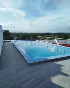 a large swimming pool on the roof of a building at Stylish Mtwapa Studio with Rooftop Pool View in Mtwapa +3 photos