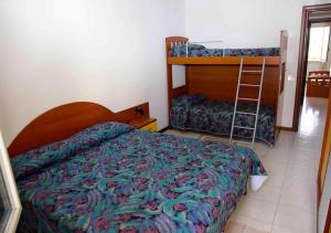 a bedroom with a bed and a bunk bed at Appartamenti Bellavista Club Tropea in Tropea