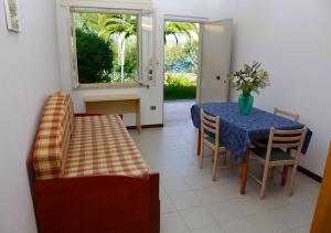 a dining room with a blue table and chairs at Appartamenti Bellavista Club Tropea in Tropea