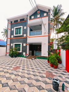 a house with a courtyard in front of it at Phoenix Villa in Kappil +16 photos