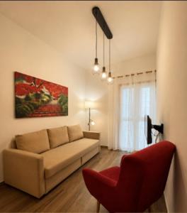 a living room with a couch and a red chair at Primero el Wiro in Puerto