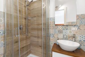 a bathroom with a glass shower with a sink at Bnb La Rocca San Vito Lo Capo in San Vito lo Capo