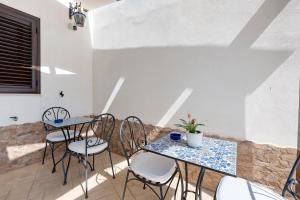 two tables and chairs sitting on a patio at Bnb La Rocca San Vito Lo Capo in San Vito lo Capo +35 photos