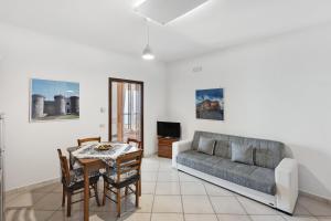 a living room with a couch and a table at Villa Azzurra in Massa Lubrense