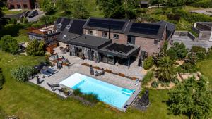 an aerial view of a house with a swimming pool at les jardins de la ferme in Soumagne