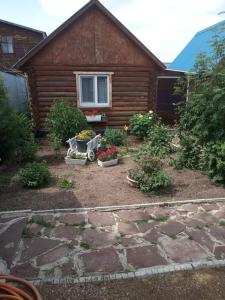 a house with a garden with flowers in front of it at Синие домики in Borovoye