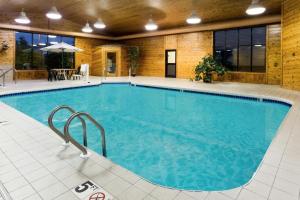 a large swimming pool in a building with a large pool at Super 8 by Wyndham Antigo in Antigo