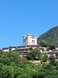 a building on top of a hill with trees at Nonna Lidie in Aymavilles