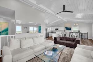 a living room with a couch and a table at All Marshed Up-Stunning Water View 1 block to beach in Surf City