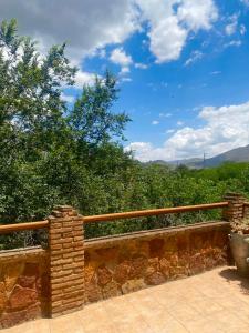 a stone fence with a view of the mountains at Villa Nadimar - Casa rural con terraza magnífica y 4 habitaciones in Benecid