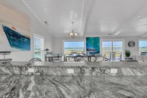 a large living room with a table and chairs at All Marshed Up-Stunning Water View 1 block to beach in Surf City