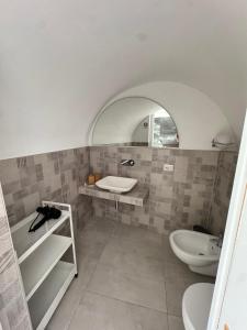 a bathroom with a sink and a toilet at Stanza dei Desideri in Peschici +2 photos