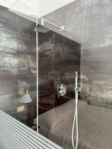 a shower with a glass door in a bathroom at Stanza dei Desideri in Peschici