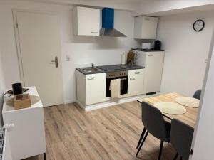 a kitchen and dining room with a table and a stove at Ferienwohnung Elli in Haiterbach