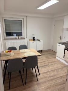 a kitchen and dining room with a table and chairs at Ferienwohnung Elli in Haiterbach