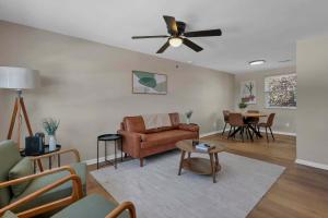 a living room with a couch and a ceiling fan at The Neff Nest - 1 BR Flat in Columbus