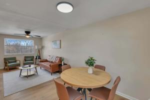 a living room with a table and chairs at The Neff Nest - 1 BR Flat in Columbus +10 photos