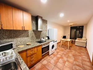 a kitchen with a sink and a dishwasher at Apartamentos Blanes Petit in Blanes +9 photos