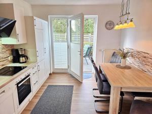 a kitchen and dining room with a table and chairs at Am Pappelweg - ABC620 in Hohen Viecheln +12 photos