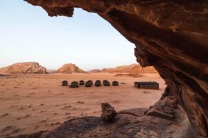 a view of a desert with domes in the distance at Wadi Rum Magic Nature Camp in Wadi Rum