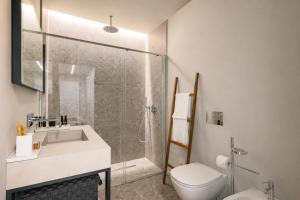 a bathroom with a shower and a toilet and a sink at La Terrazza - Private Jacuzzi in Downtown Como in Como