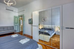 a bedroom with two beds and a mirror at Riva Luxury Seafront in Rabac