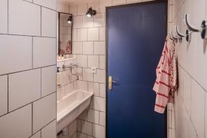 a blue door in a bathroom with a sink and a tub at Eklo Hotels Lille in Lille +41 photos