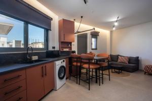 a kitchen and living room with a table and chairs at Central Point - Kallithies Village Square by GM in Kalithies