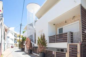 a street view of a building with balconies at Central Point - Kallithies Village Square by GM in Kalithies