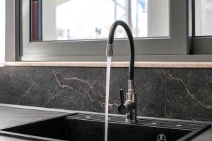 a kitchen sink with a water faucet at Central Point - Kallithies Village Square by GM in Kalithies +66 photos