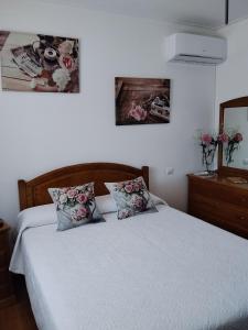a bedroom with a bed and two pictures on the wall at Lélé in Vila Praia de Âncora +25 photos