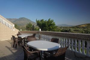 two tables and chairs on a balcony with mountains at Bab Akchour in Chefchaouen