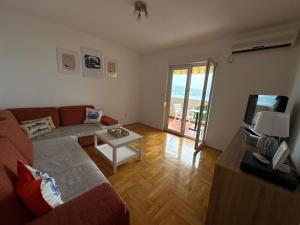 a living room with a couch and a table at Boke vidik in Savina