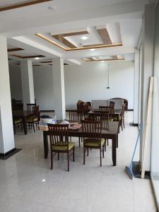 a dining room with wooden tables and chairs at Hill View Hotel in Astor +32 photos