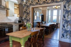 a kitchen with a wooden table and chairs in a room at Ryburn Lodge in Bridlington