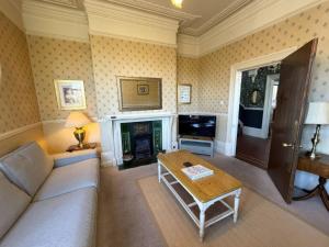 a living room with a couch and a fireplace at Ryburn Lodge in Bridlington