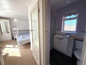 a bathroom with a sink and a toilet and a window at Ryburn Lodge in Bridlington +28 photos