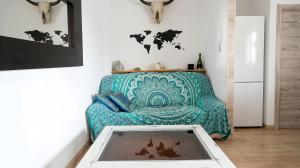a living room with a couch and a table at Apartamento Aguamarina con terraza in Chiclana de la Frontera