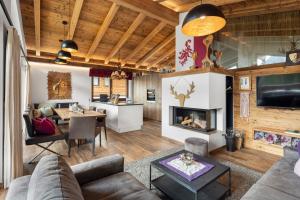 a living room with a couch and a fireplace at Nationalpark Chalet Blessachkopf in Neukirchen am Großvenediger