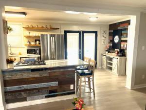 a kitchen with a counter and a stove top oven at A Poolside Paradise in Pensacola