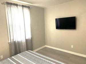 a bedroom with a flat screen tv on the wall at A Poolside Paradise in Pensacola +18 photos