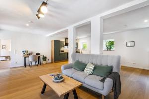 a living room with a couch and a table at Ferienhaus Lilla Huset in Neheim-Hüsten