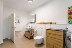 a bathroom with a toilet and a sink at Ferienhaus Lilla Huset in Neheim-Hüsten +27 photos