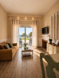 a living room with a couch and a table at Galinio Boutique Apartments in Skafidia