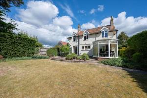 a large white house with a large yard at The White House, Tunstall in Tunstall