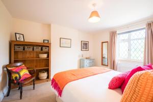 a bedroom with a bed and a chair and a window at The White House, Tunstall in Tunstall