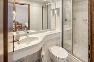 a bathroom with a sink and a toilet and a shower at Hotel Deitmer in Rhede +126 photos