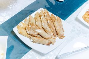 a white plate of food on a table at Art Tashkent Hotel in Tashkent