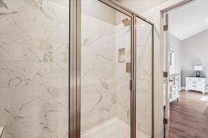 a shower with a glass door in a bathroom at THE VIEW Hot Tub Fire Pit Private in McHenry +65 photos